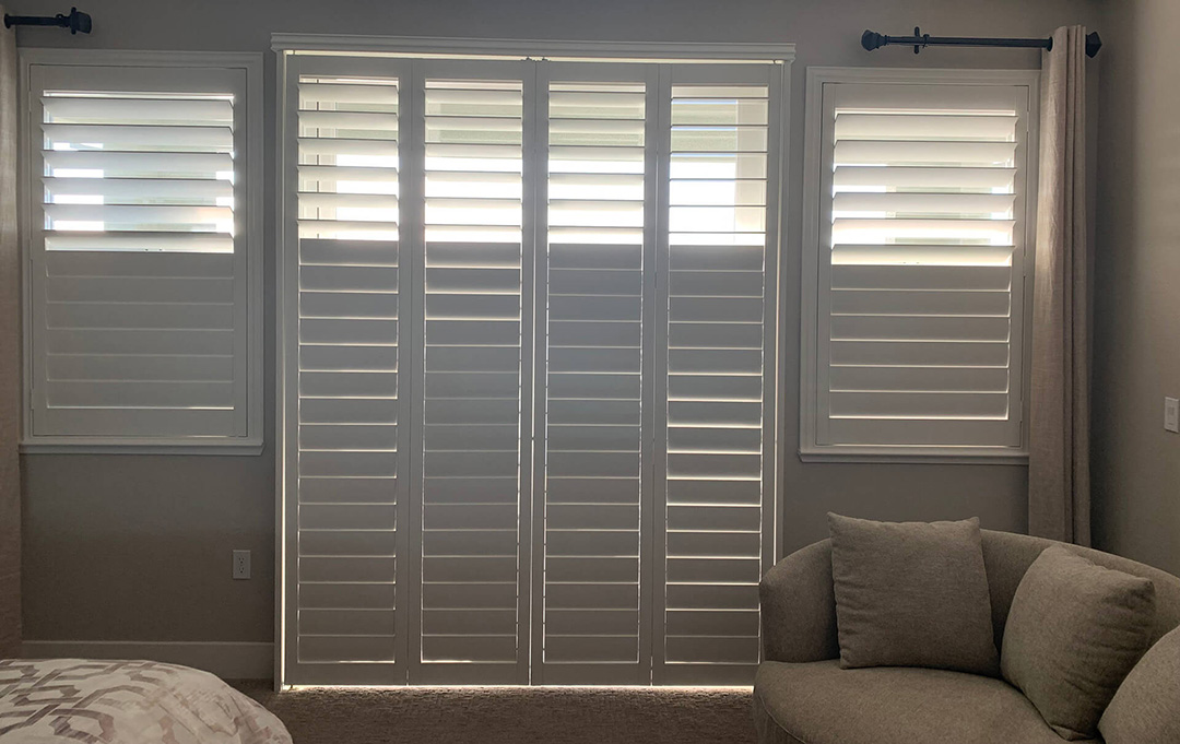 A white seating area with shutters completely covering the doors and windows.