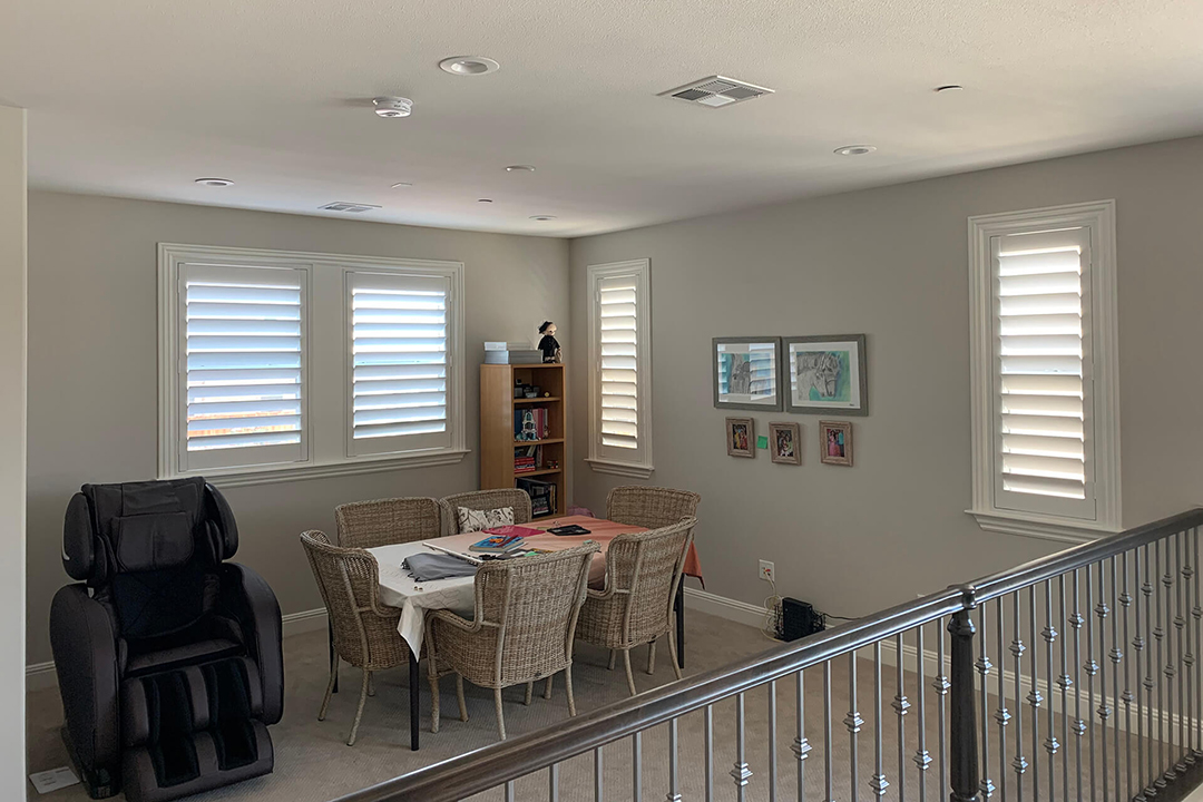 A family loft area with plantation shutters covering the windows.
