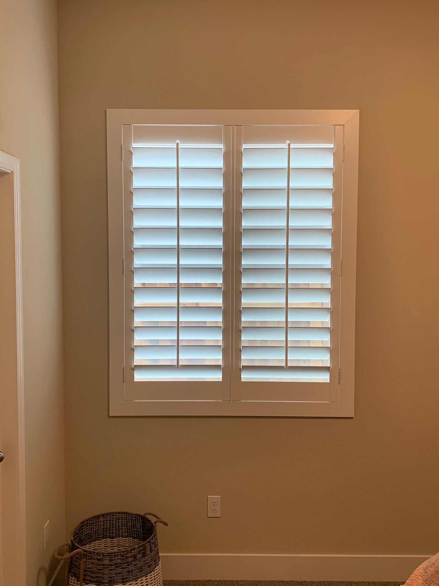 A single window covered with basic shutters