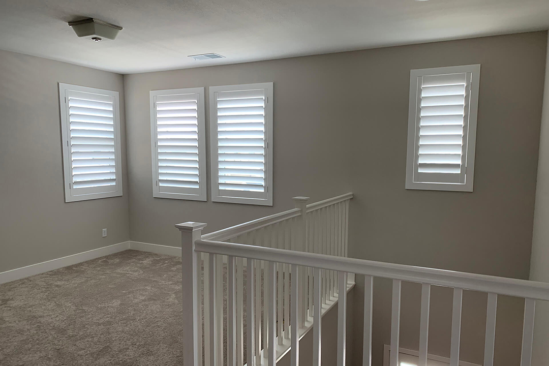 An empty loft with shutters covering all windows.