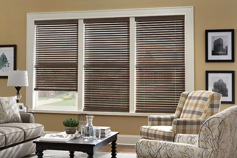 A yellow living room with brown blinds covering the windows